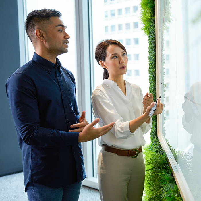 People at a whiteboard collaborating